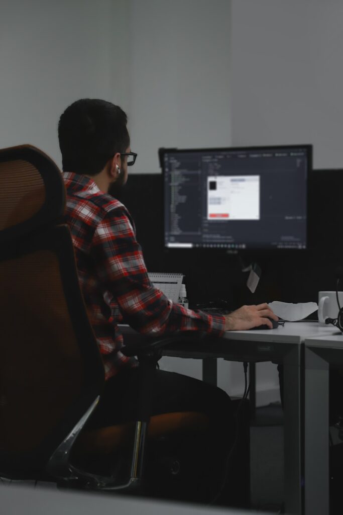 a man sitting at a desk with a computer